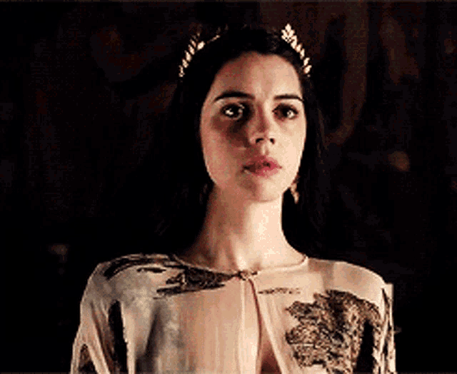 a woman wearing a crown and a floral dress