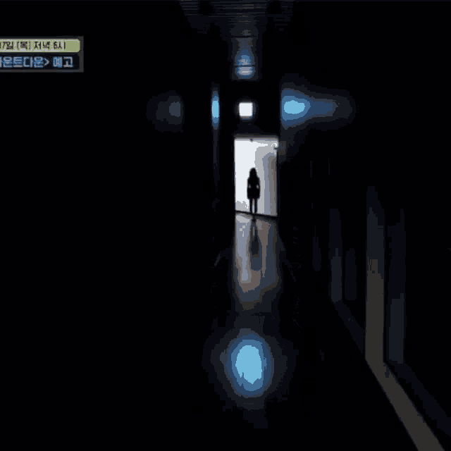 a woman is standing in a dark hallway wearing a scarf around her neck