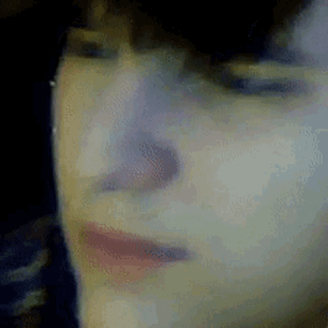 a close up of a person 's face with their eyes closed .