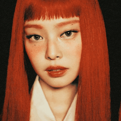 a woman with red hair and freckles on her face