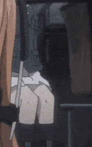 a little girl is sitting in a chair with a person holding her skirt up .