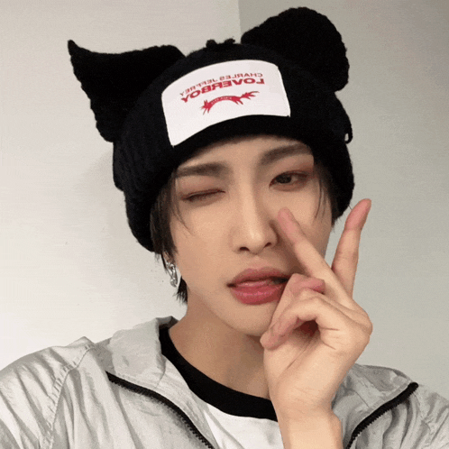 a person wearing a black beanie with a patch on it that says ' yacobca ' on it