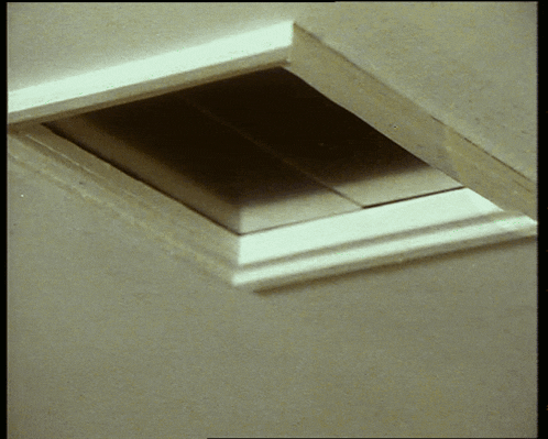 a square hole in a wall with a white frame