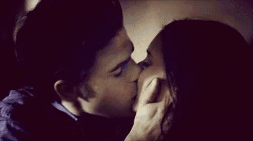 a man and a woman are kissing each other on the cheek .