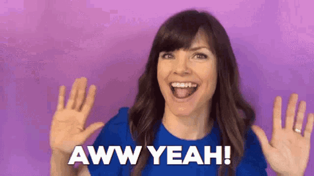 a woman in a blue shirt is making a funny face and saying aww yeah