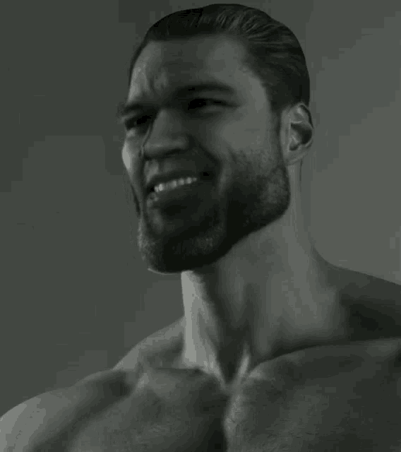 a shirtless man with a beard is smiling