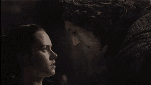 a man and a woman are looking at each other .