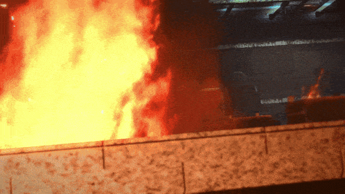 a large fire is burning in a dark room with the word fire visible