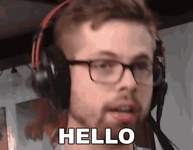 a man wearing glasses and headphones is saying hello