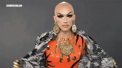 a woman with a bald head is wearing a fur coat and earrings