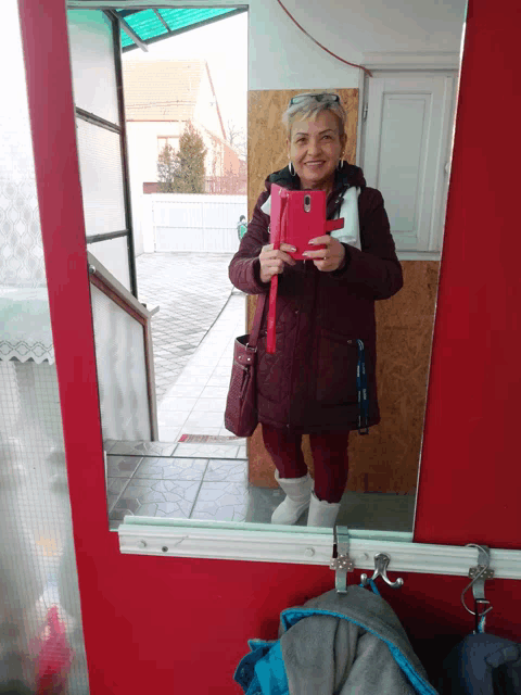 a woman is taking a picture of herself in the mirror