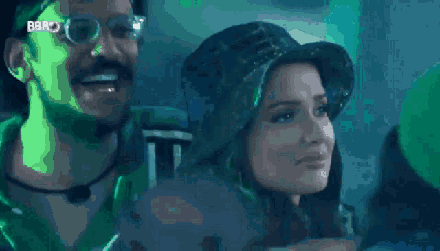 a woman in a black hat is looking at a skull in a green jacket