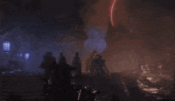 a group of people are walking down stairs in a dark area