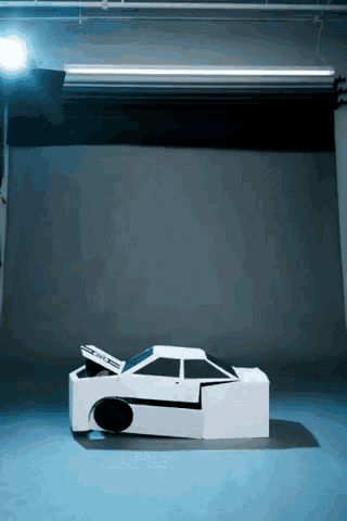 a cardboard model of a car with the hood open and a sticker on the side that says ' a '