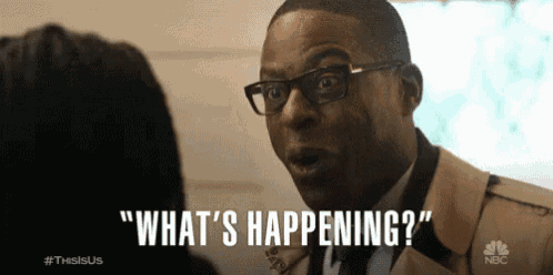 a man in glasses is talking to a woman and says " what 's happening "