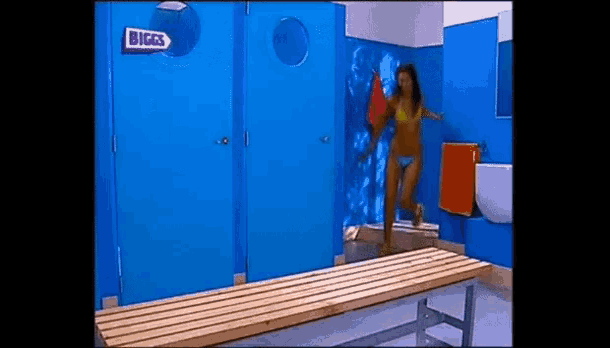 a woman in a bikini is standing in a changing room with a sign that says biggs