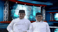 two men are standing next to each other in front of a screen