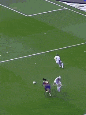 a soccer player wearing a number 11 jersey is being tackled by another player