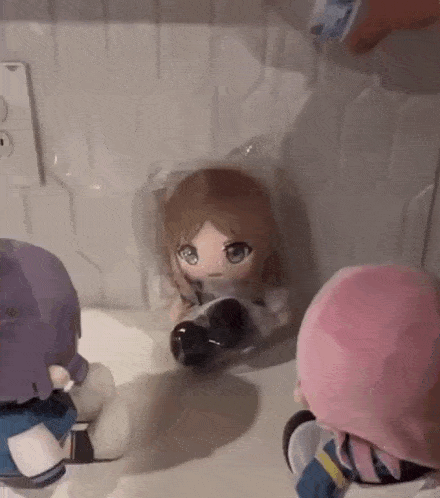 three stuffed dolls are sitting on a counter .