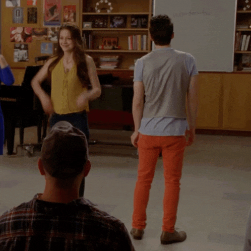 a group of people are dancing in front of a white board that says ' amanda '