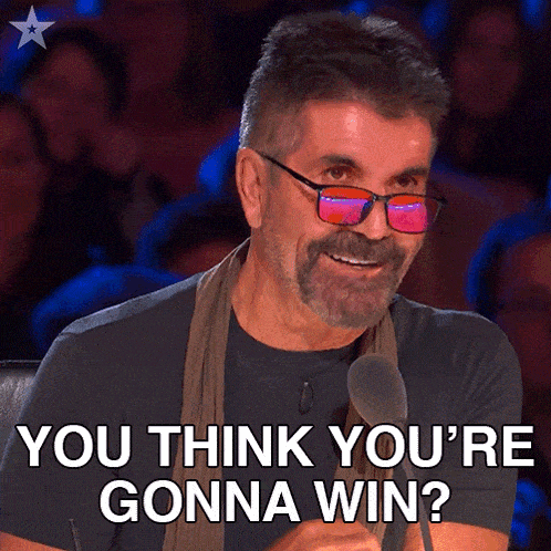 a man with glasses and a beard is smiling and says you think you 're gonna win