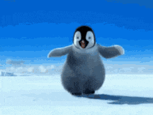 a baby penguin is standing in the snow with its arms outstretched