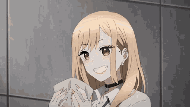 a girl with blonde hair is holding a piece of paper in her hands