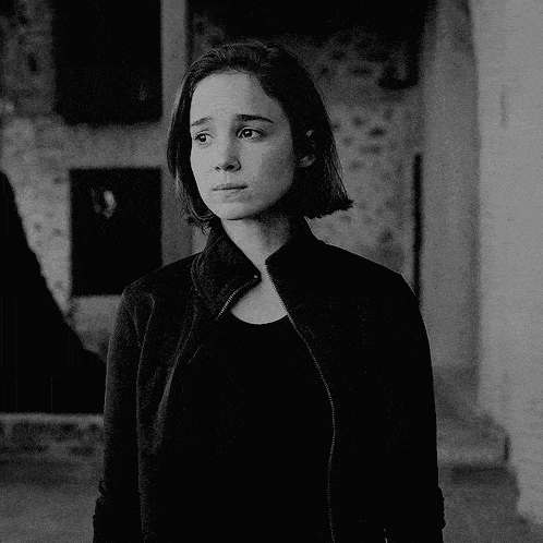 a black and white photo of a woman wearing a leather jacket