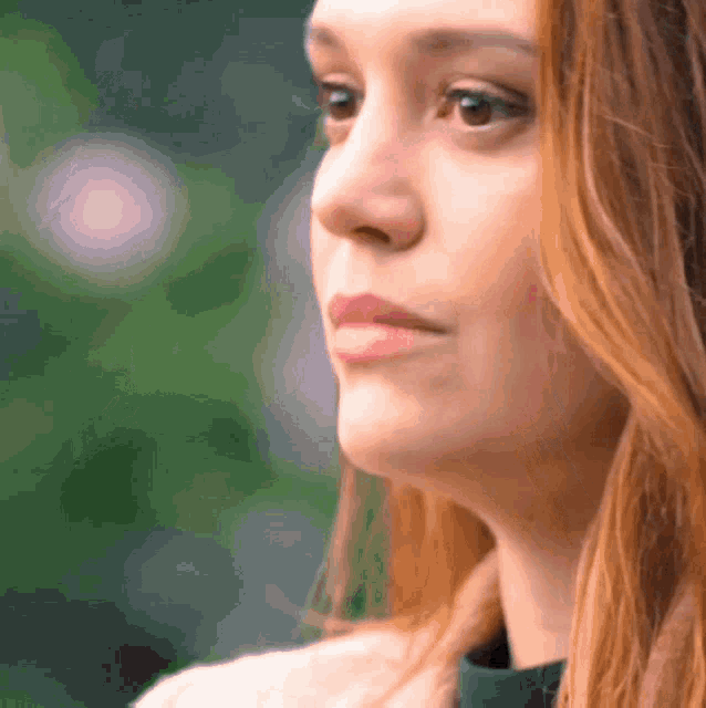 a close up of a woman 's face with her eyes closed