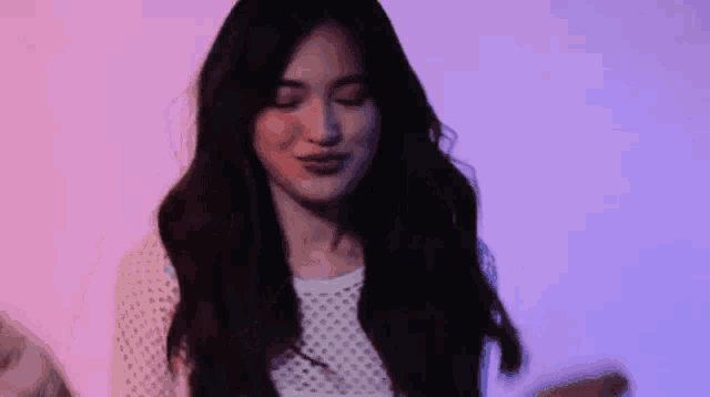 a woman with long hair is making a funny face
