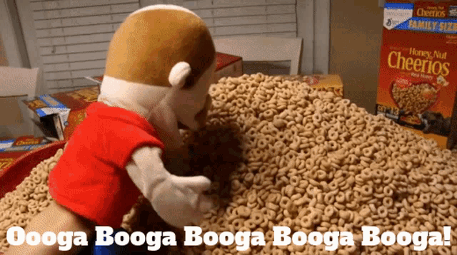 a stuffed animal is standing on a pile of cheerios