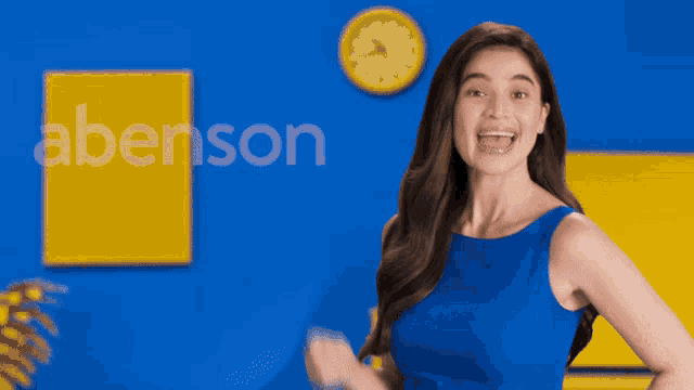 a woman stands in front of an abenson sign