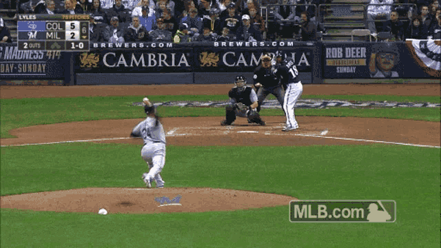 a baseball game is being played in front of an advertisement for cambrian