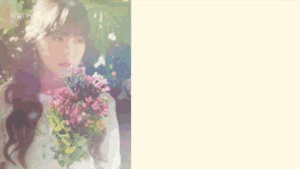 a woman in a white dress is holding a bouquet of flowers .