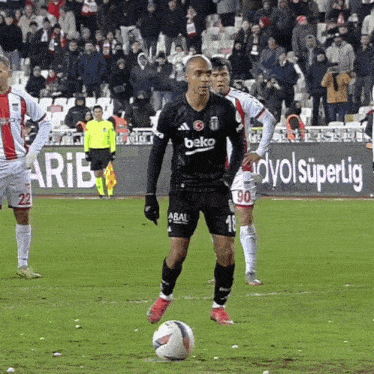 a soccer player in a beko jersey kicks the ball