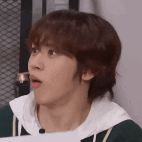 a close up of a young man making a funny face .