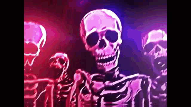 a group of skeletons are dancing in a dark room with purple lights behind them .