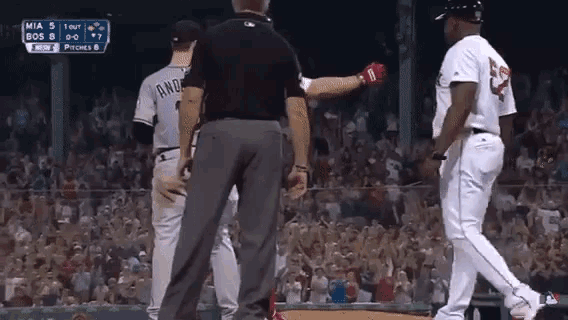 a baseball player with the number 23 on his jersey talks to a referee