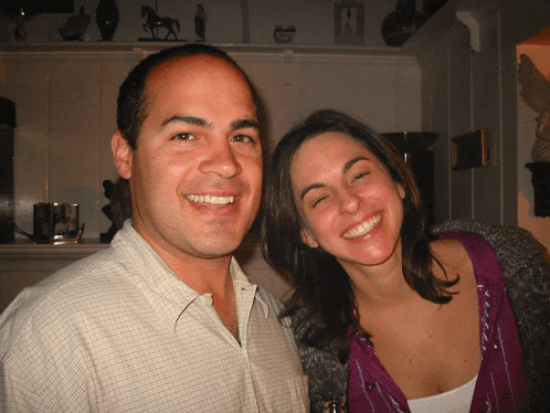 a man and woman are posing for a picture and the woman is wearing a purple shirt