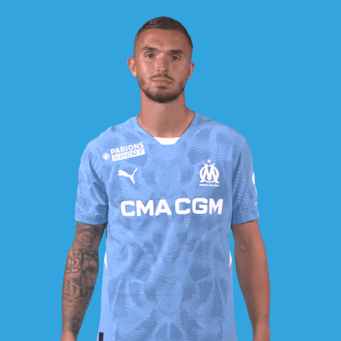 a man wearing a light blue shirt that says cma cgm