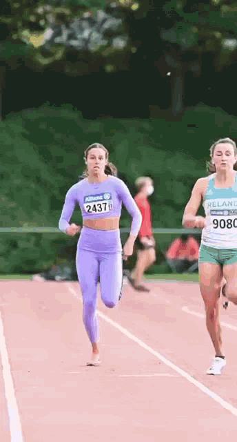 a woman in a purple top with the number 1437 on it is running on a track