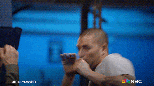 a man in a white shirt is boxing with the nbc logo visible