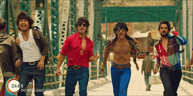 a group of men are running across a bridge with the words zee5 download now on the bottom