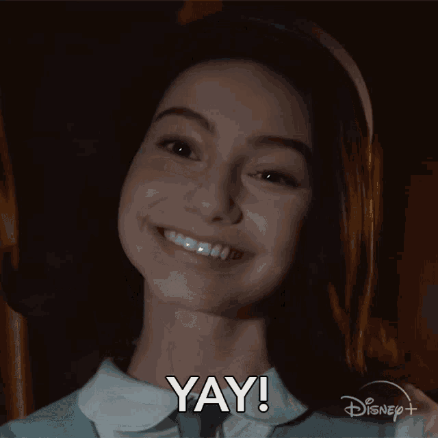 a girl is smiling and saying yay on disney plus