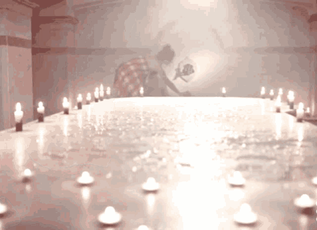a table with candles on it and a shadow of a person in the background
