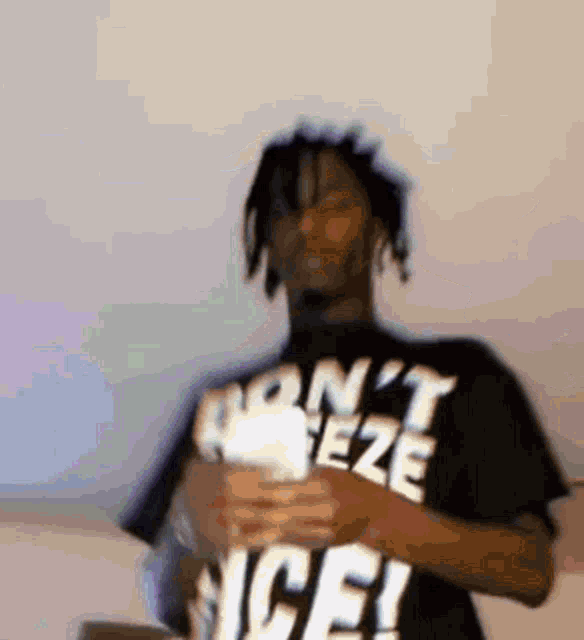 a blurry picture of a man wearing a shirt that says ' don 't freeze ice ' on it