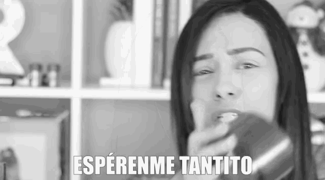 a black and white photo of a woman with the words " esperanme tantito " written above her