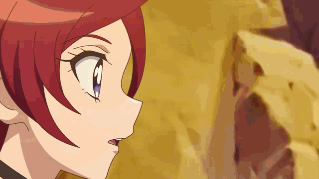 a girl with red hair and purple eyes is looking at something
