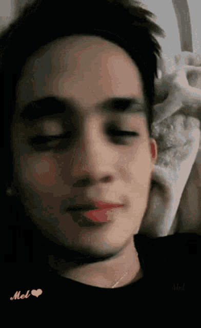 a close up of a man 's face with a pink heart in the corner