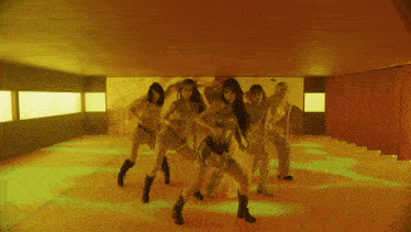 a group of women are dancing in a room